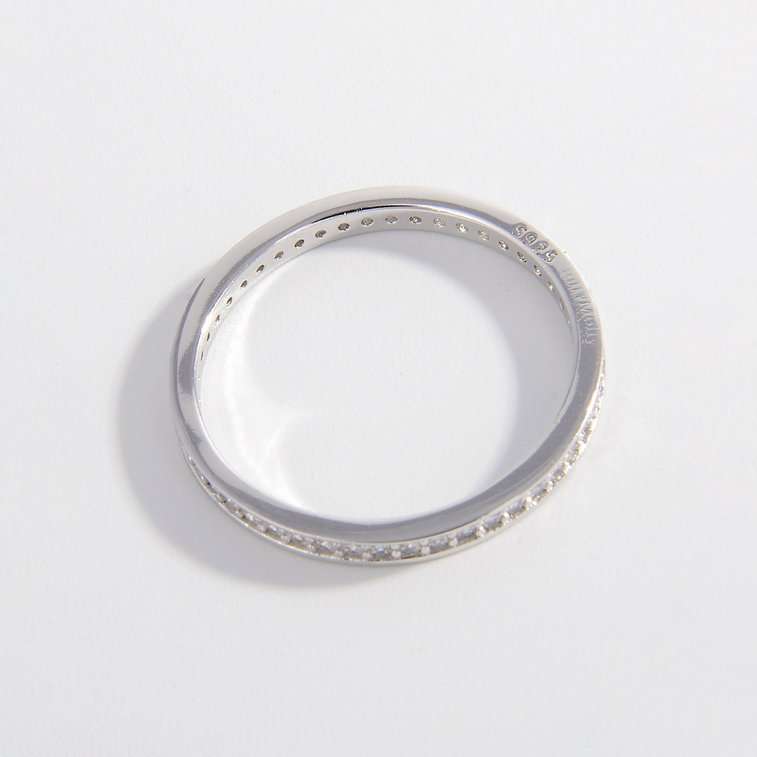 a white gold wedding band with small diamonds