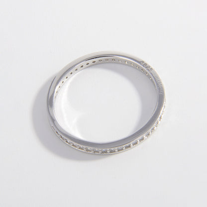 a white gold wedding band with small diamonds