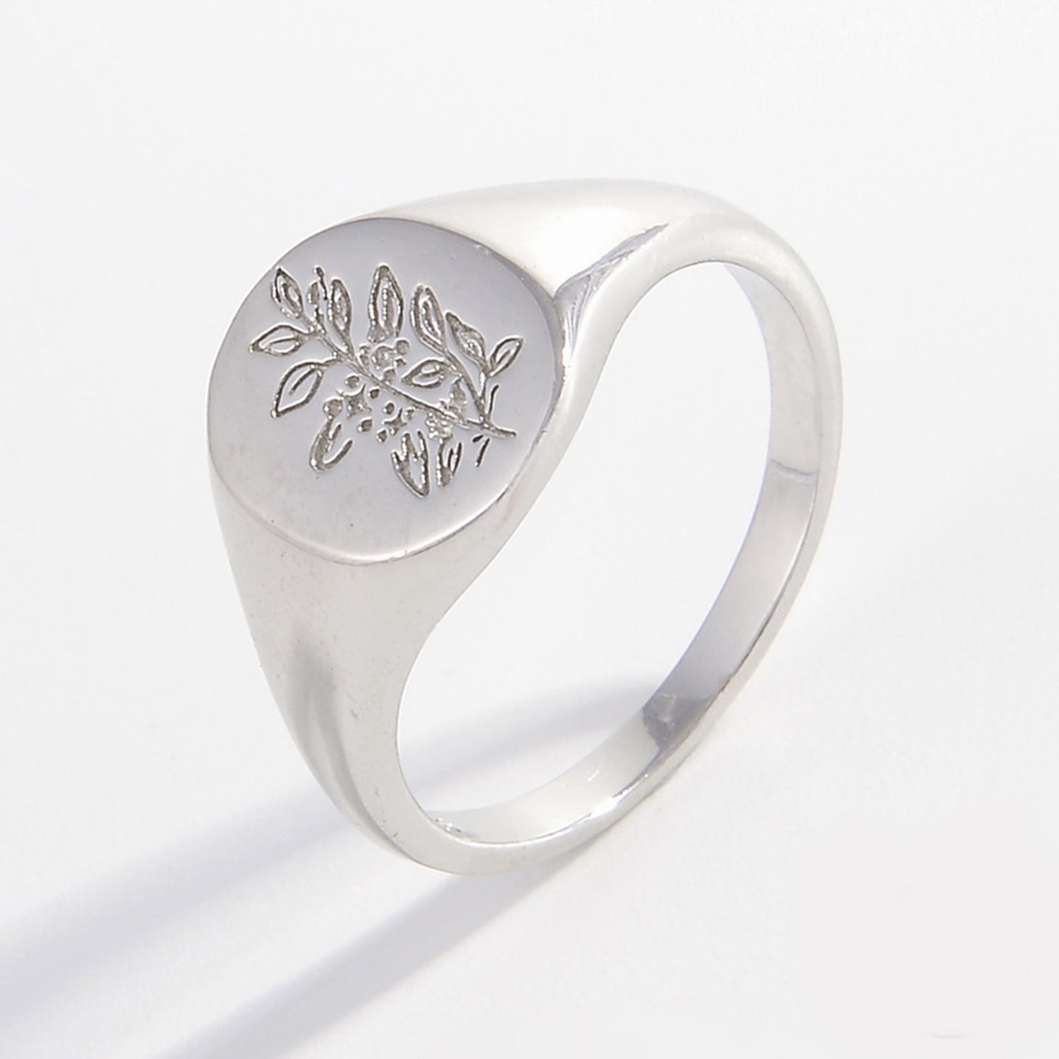 a silver ring with a flower design on it