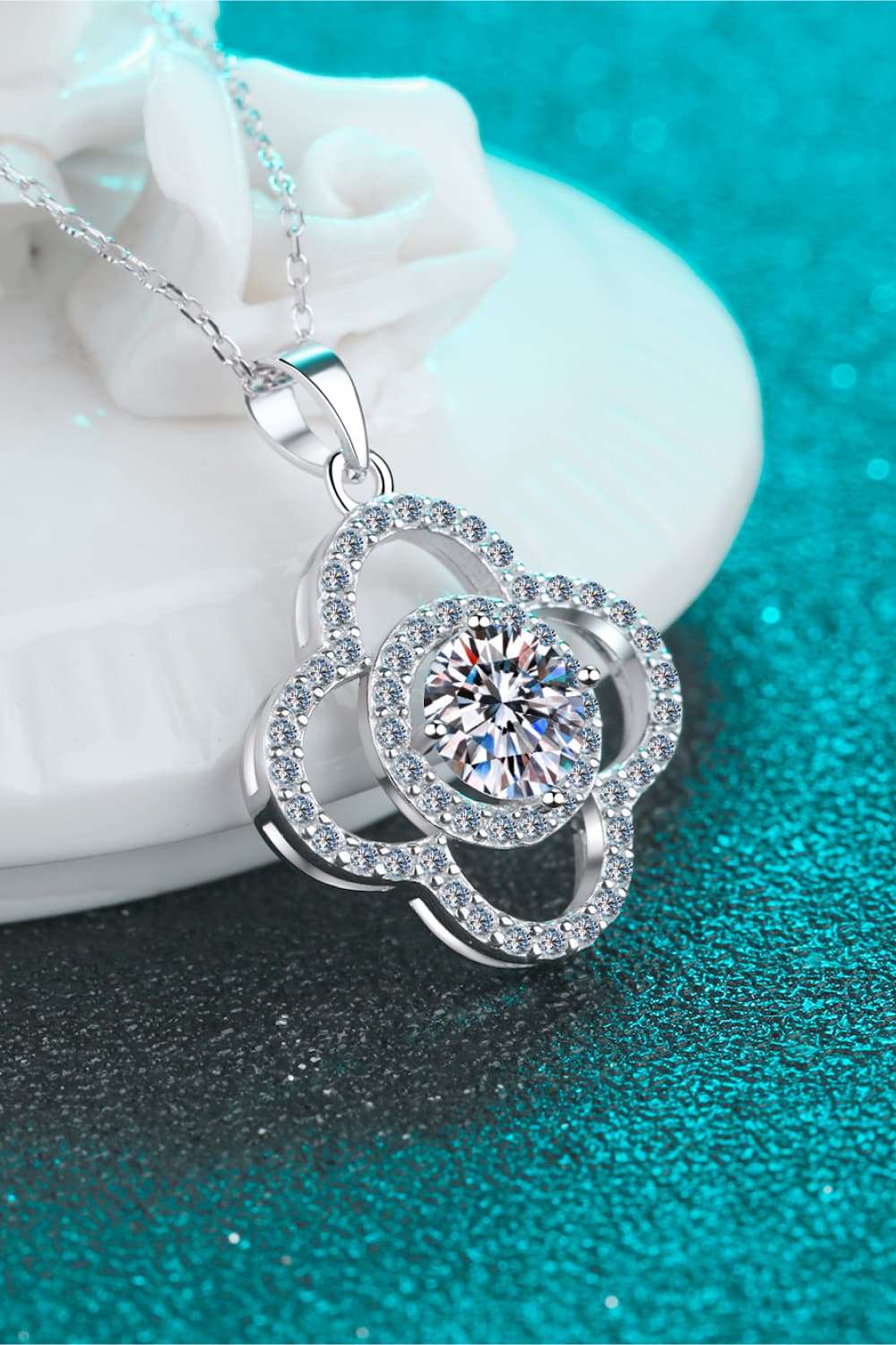 Elegant Moissanite Pendant Necklace - Sparkling 1 carat moissanite center stone set in a sterling silver floral design with shimmering accent stones.