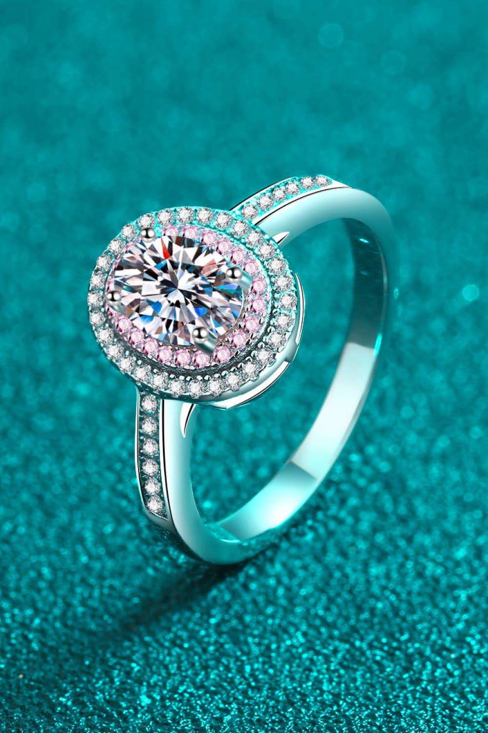 Elegant Moissanite Engagement Ring on Sparkling Teal Background