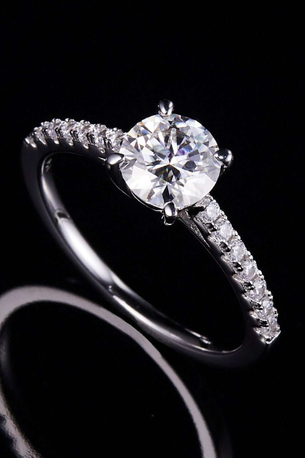 Elegant sterling silver engagement ring with large round-cut moissanite center stone and sparkling side stones