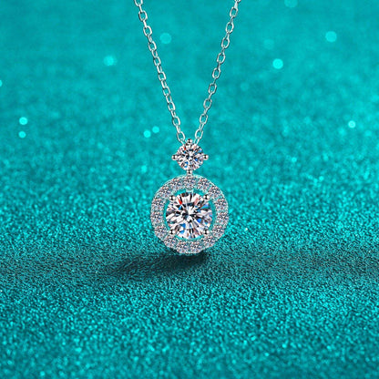 Elegant 1 Carat Moissanite Necklace in Sterling Silver on Turquoise Background