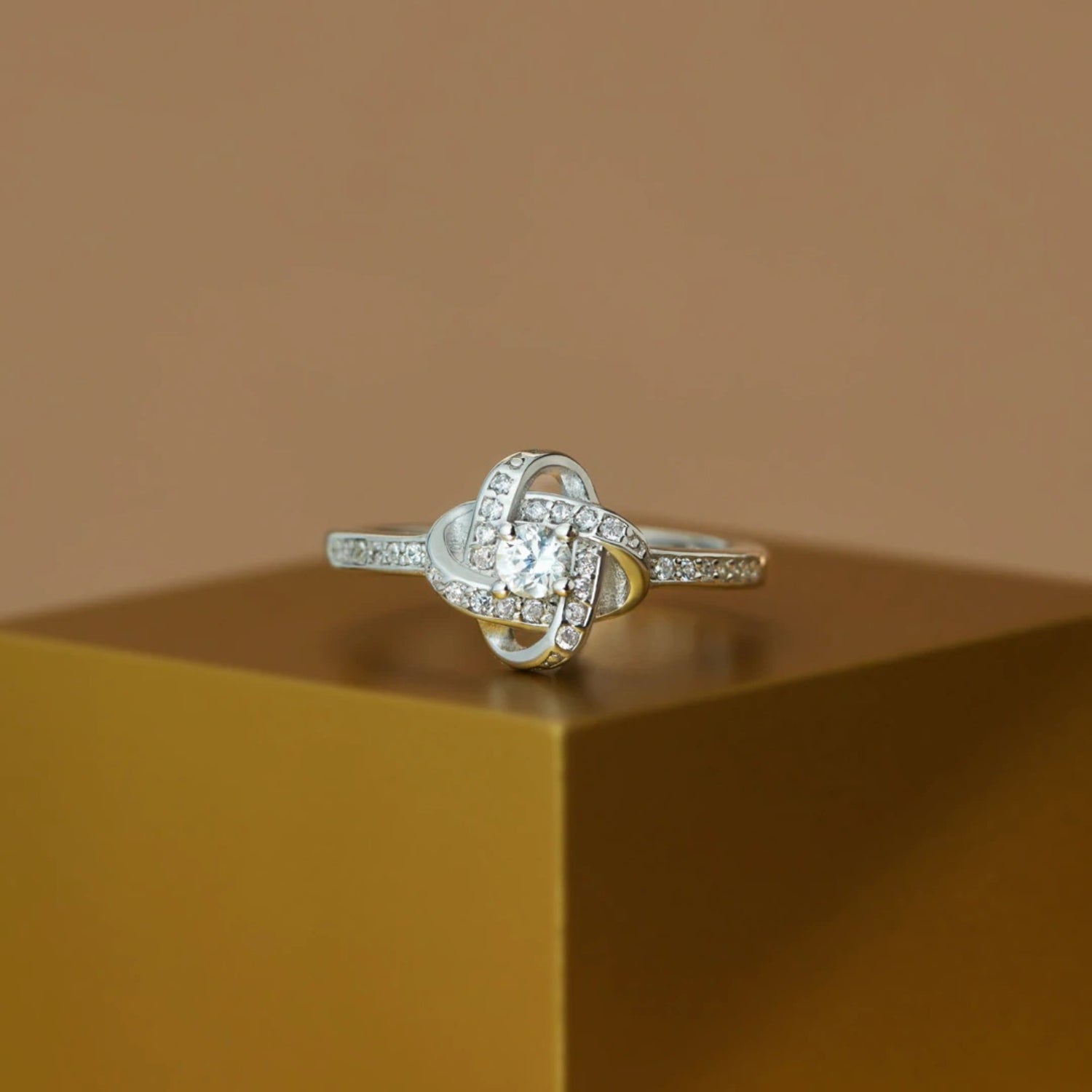 a diamond ring sitting on top of a wooden box