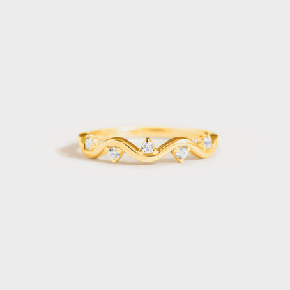 a gold ring with three diamonds on it