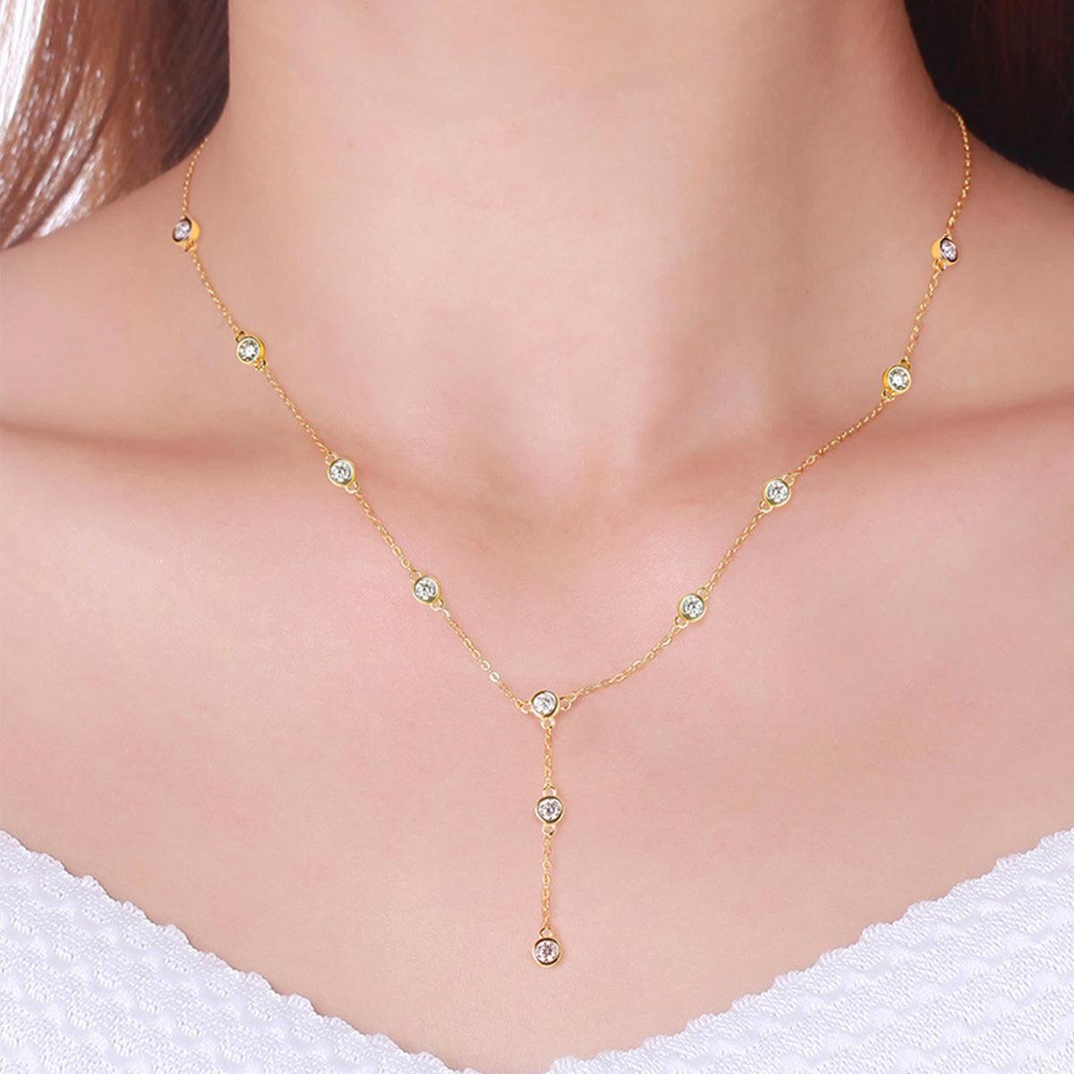 Elegant Moissanite Necklace: 1.1 Carat Moissanite 925 Sterling Silver Necklace showcases sparkling gemstones on a delicate gold-toned chain, accentuating the wearer's refined style.