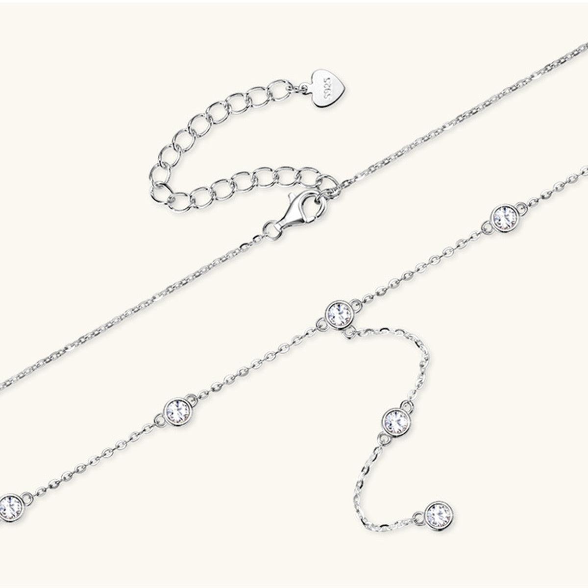 Delicate sterling silver necklace with sparkling moissanite stones set along the chain, creating an elegant and timeless look.