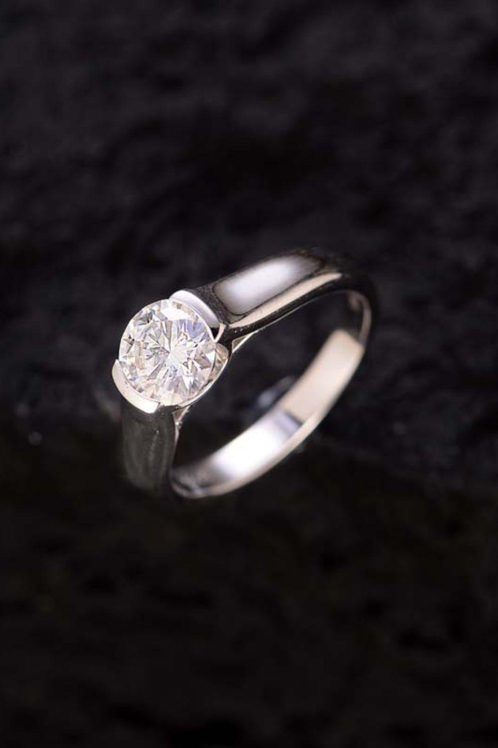 Elegant diamond solitaire ring shining in the dark background