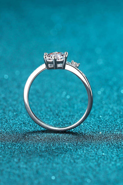 Elegant moissanite ring on sparkling teal background