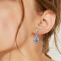 Elegant sterling silver earrings with sparkling blue moissanite gemstones