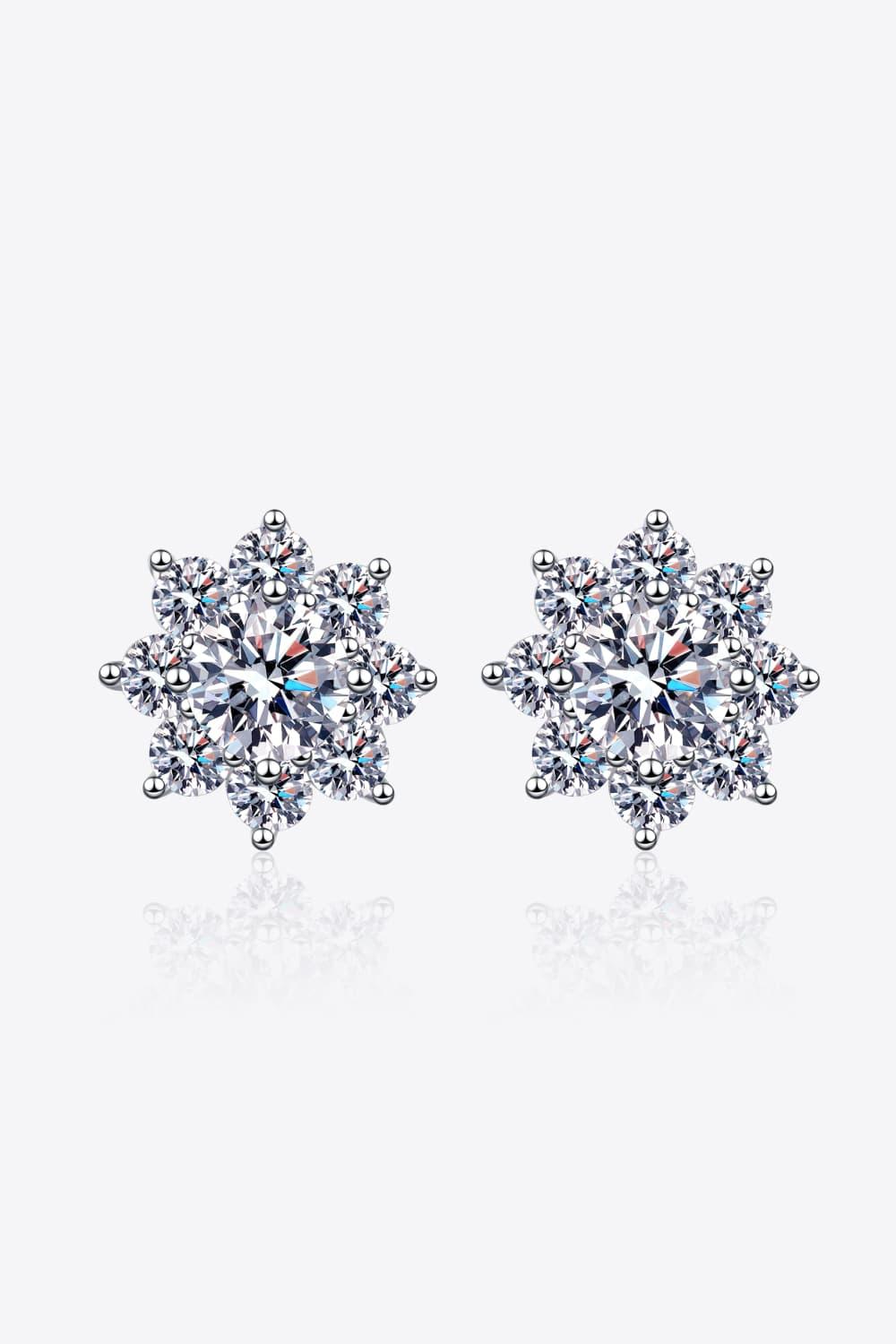 Elegant flower-shaped sterling silver earrings featuring sparkling moissanite gemstones.