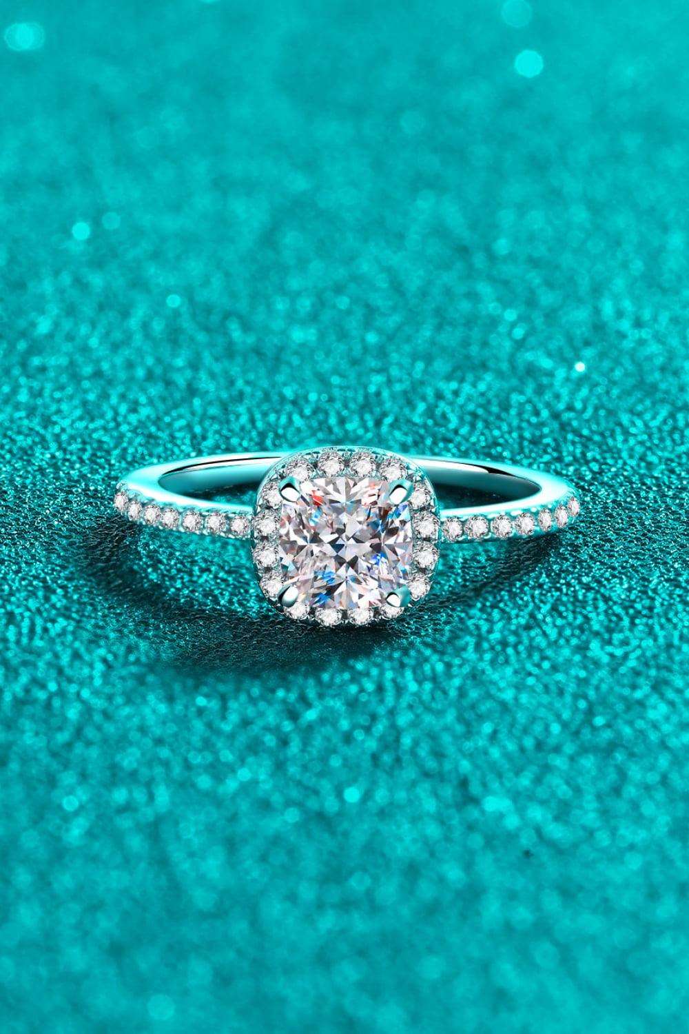 Sparkling diamond engagement ring on turquoise background