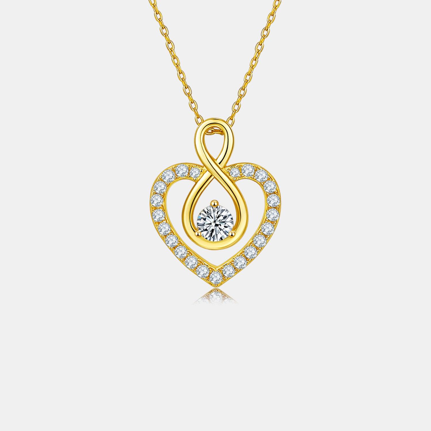 Elegant heart-shaped sterling silver necklace with moissanite center stone and sparkling cubic zirconia accents in a gold-plated setting.