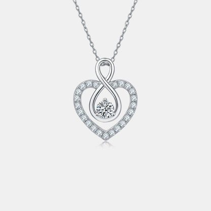 Elegant sterling silver heart-shaped necklace with 1 carat moissanite center stone and sparkling cubic zirconia accents.