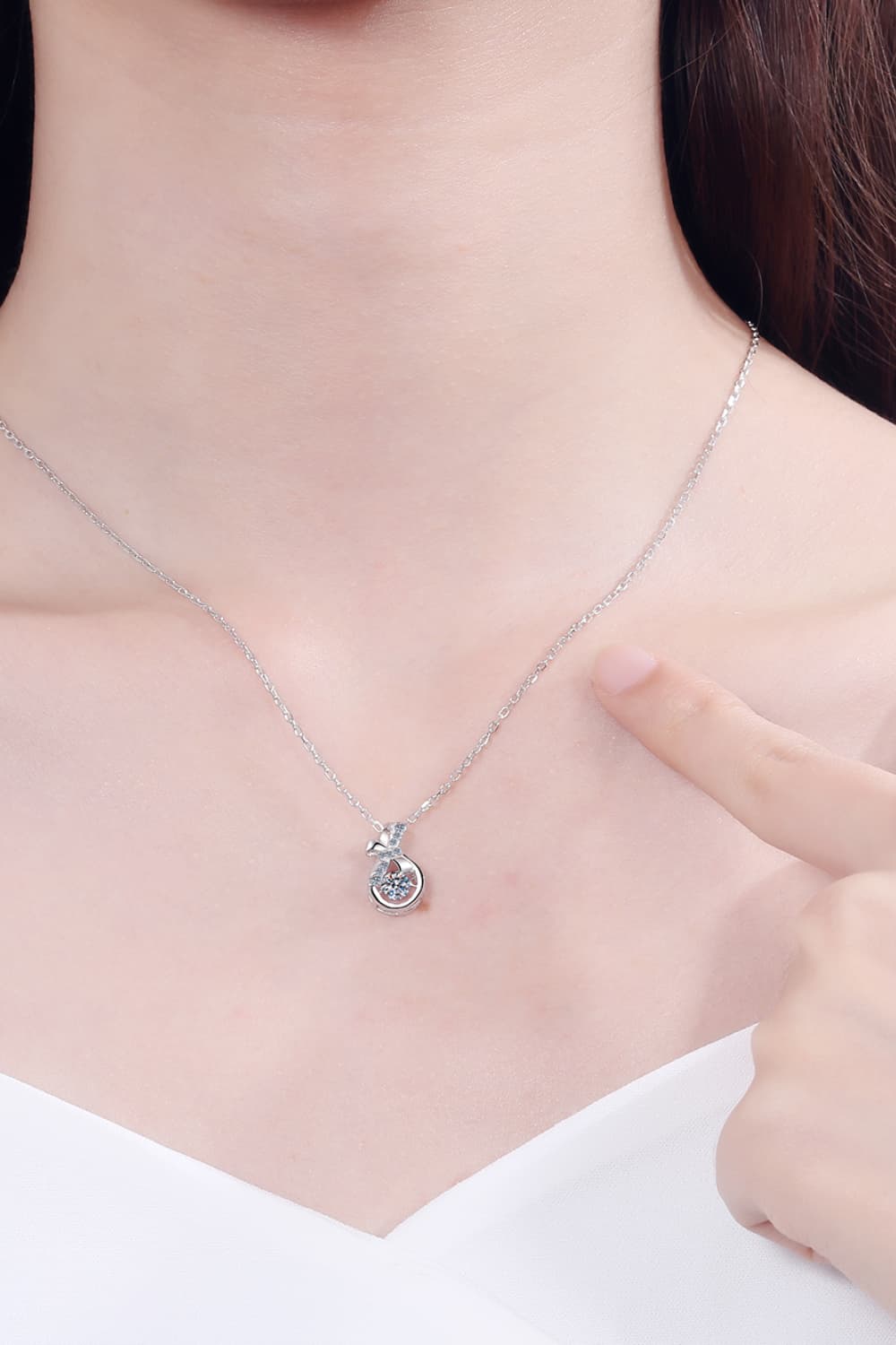 Elegant 1 Carat Moissanite Sterling Silver Necklace displayed on model's neck against dark background