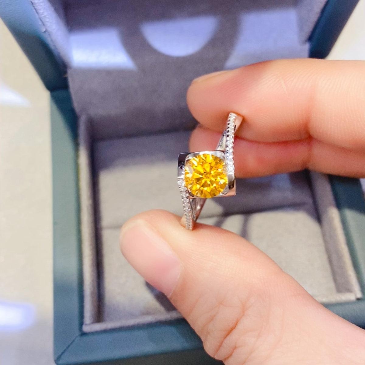 Stunning 1 Carat Moissanite 925 Sterling Silver Ring with a vibrant yellow center stone surrounded by glittering diamonds, displayed in an elegant jewelry box.