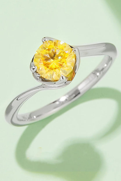 Elegant sterling silver ring showcasing a brilliant 1 carat moissanite center stone in a vibrant yellow hue, set in a classic solitaire design.