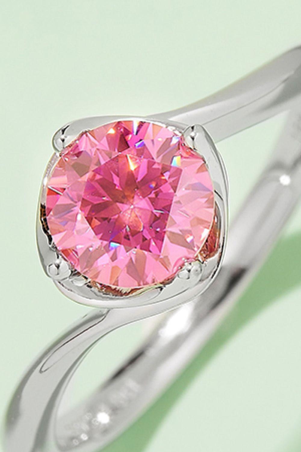 Elegant sterling silver solitaire ring with a large, vibrant pink moissanite gemstone