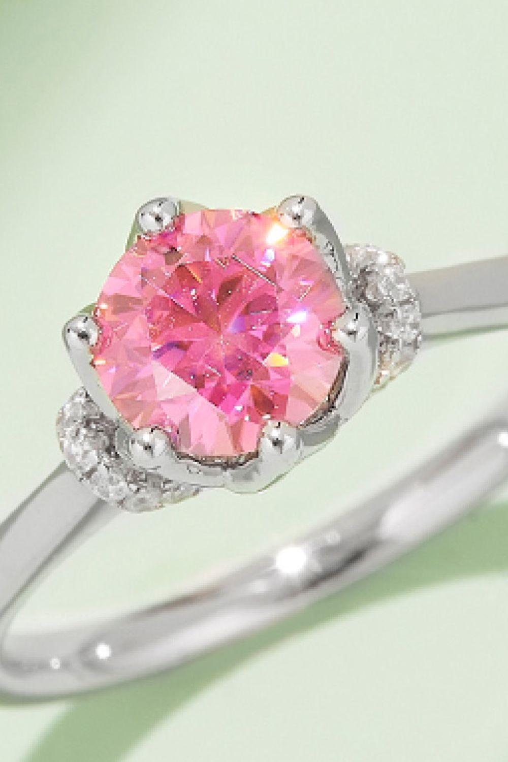 Radiant pink moissanite gemstone ring on sterling silver band with shimmering diamond accents