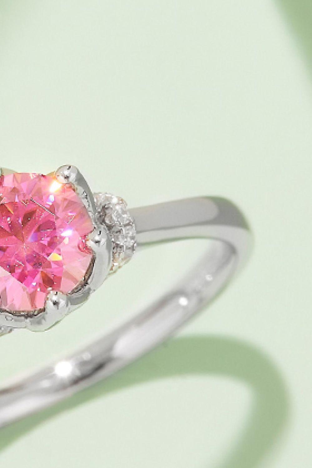 Elegant sterling silver ring with a large pink moissanite gemstone and sparkling diamond accents