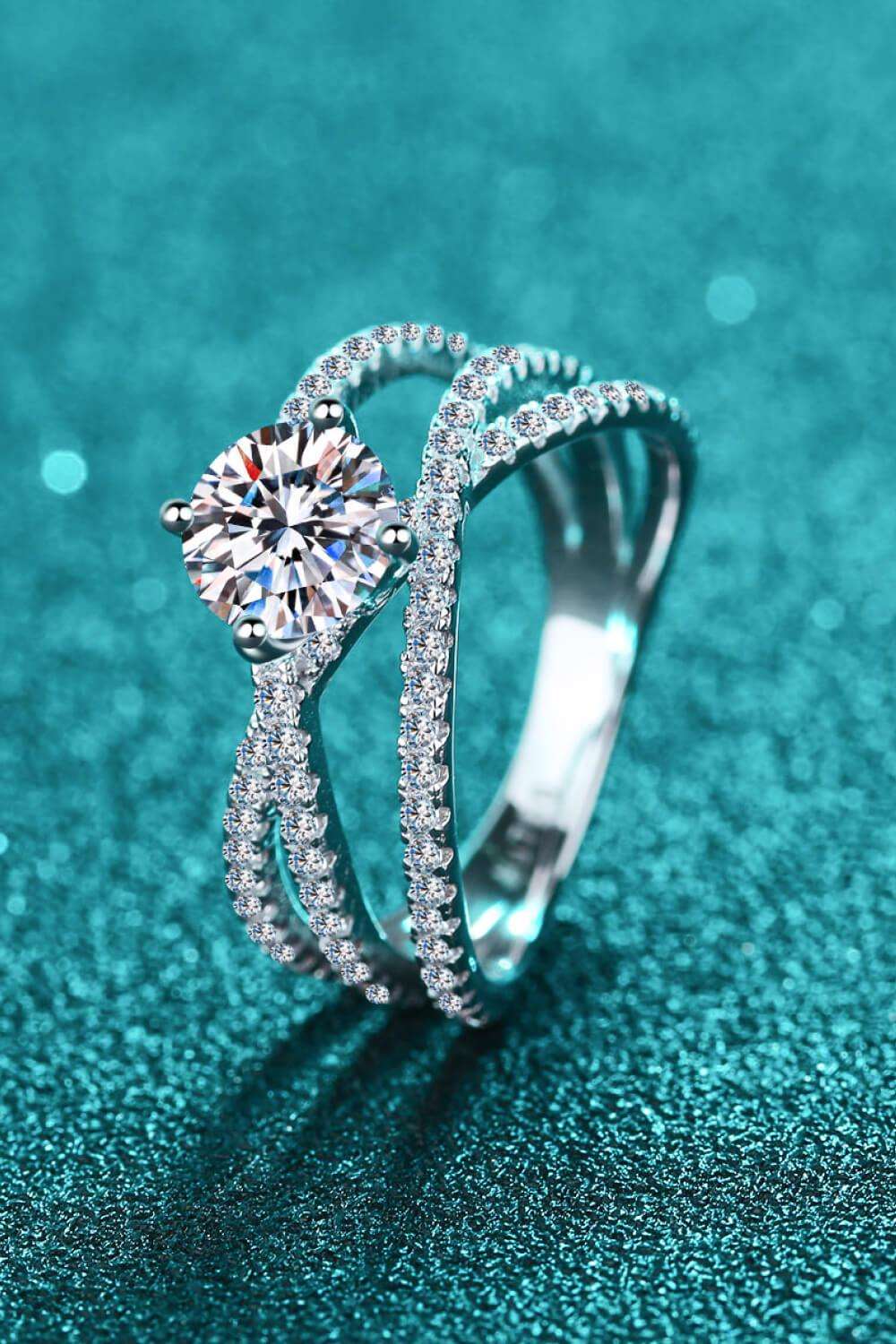 Sparkling diamond engagement ring on teal background