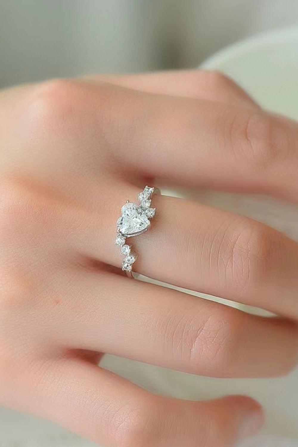 Elegant sparkling heart-shaped moissanite ring on a woman's hand