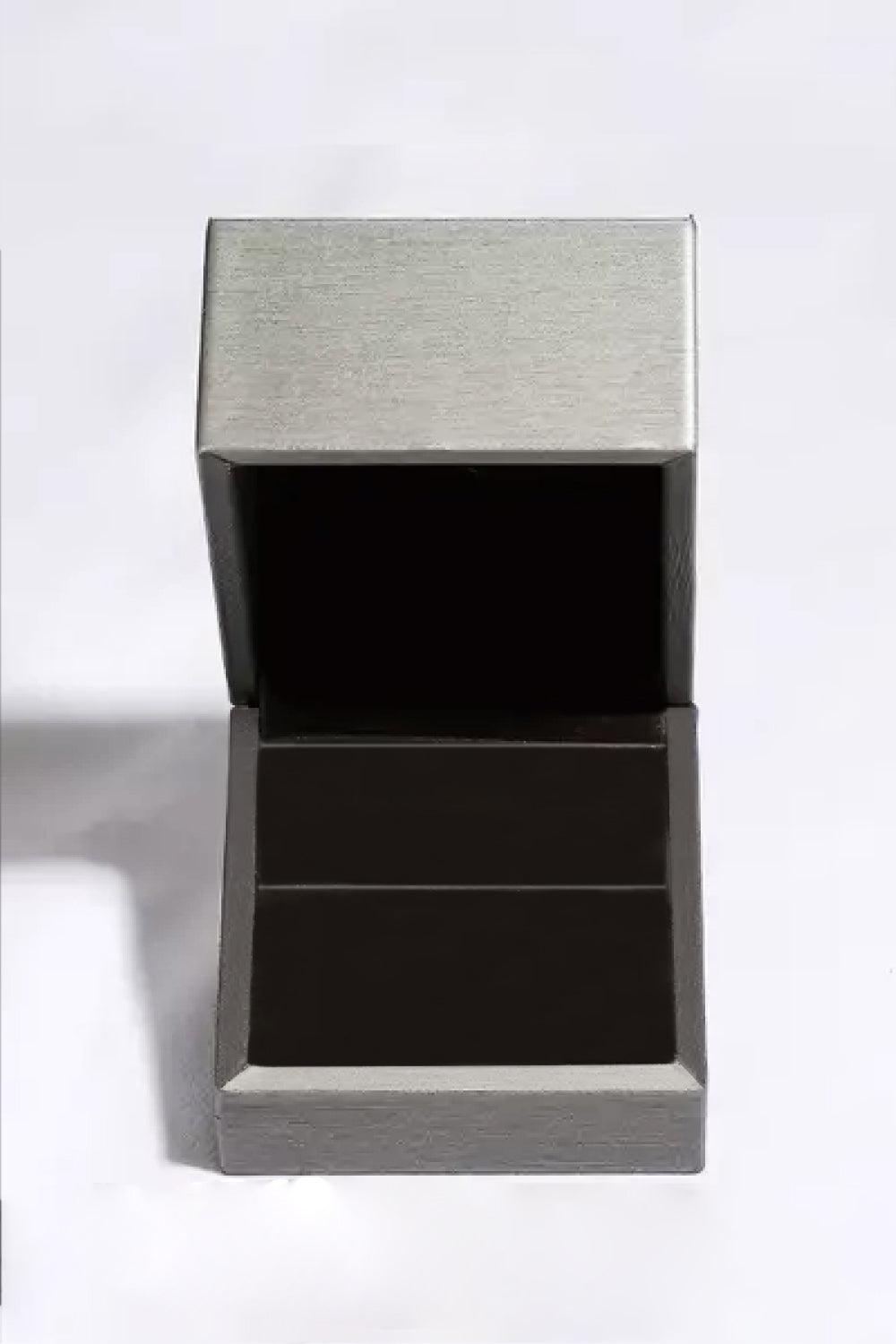 Elegant silver-toned jewelry box with a sleek black design, displaying a 1 Carat Moissanite Heart 925 Sterling Silver Ring.