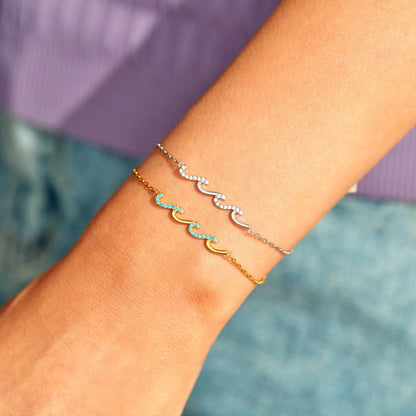 a woman's arm with three bracelets on it