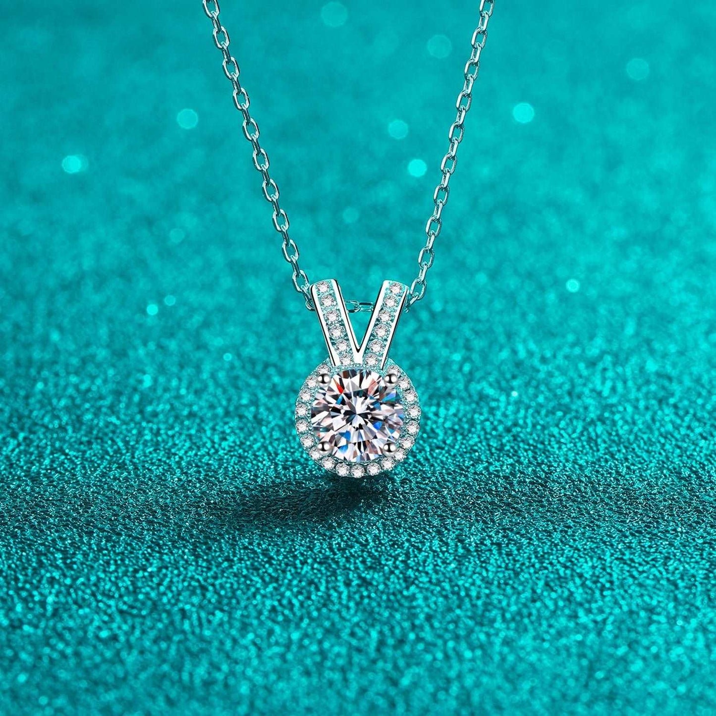 Elegant Moissanite Rabbit Ears Pendant Necklace on Teal Background