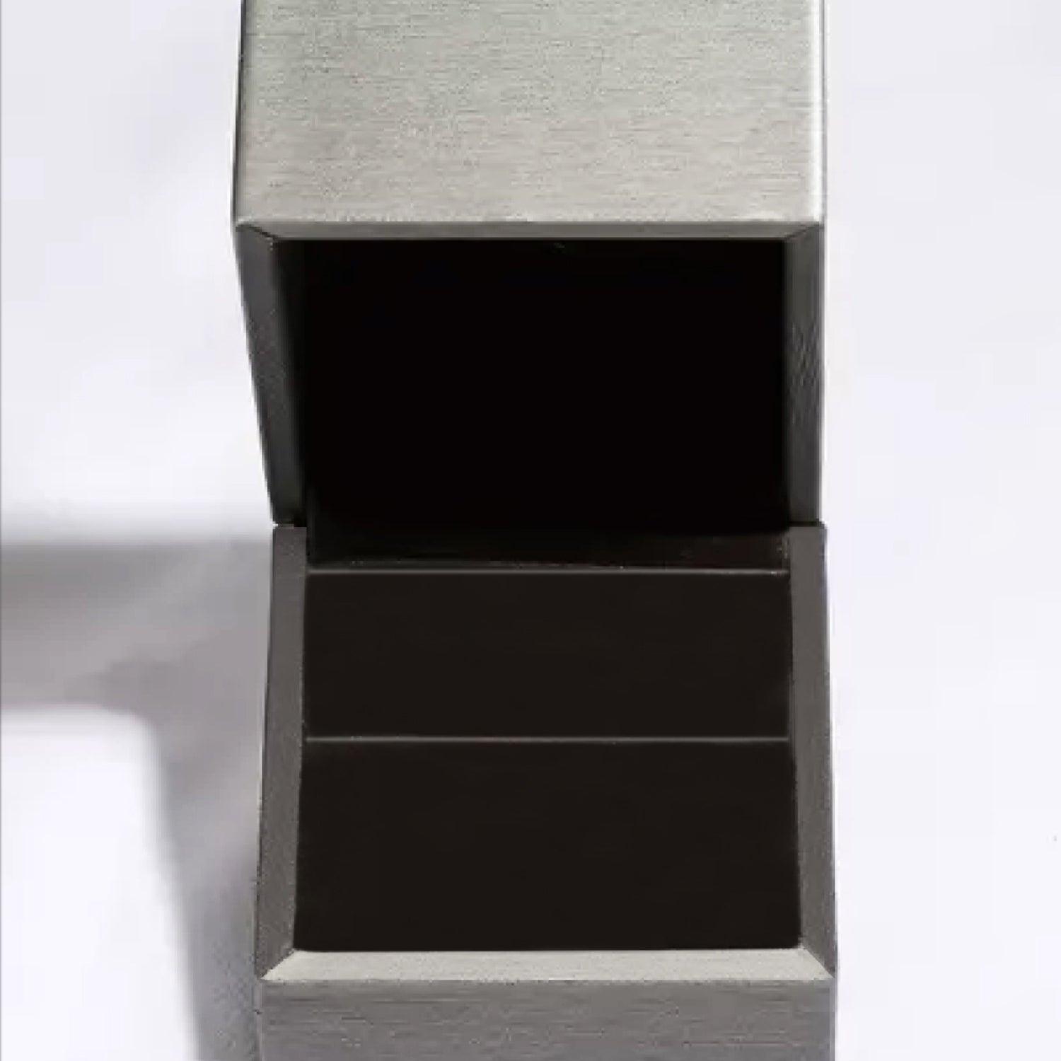 Elegant silver and black jewelry box showcasing a premium moissanite ring