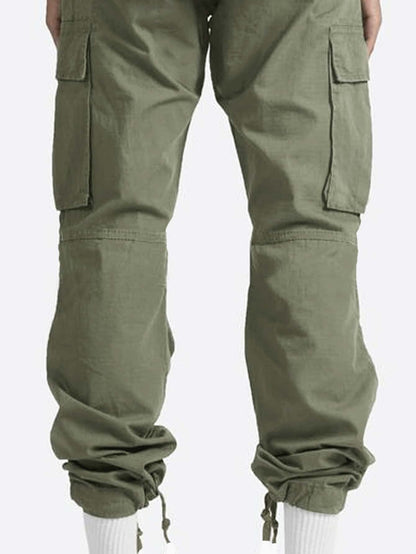 a man wearing a pair of green cargo pants