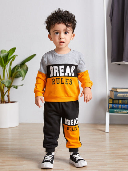 a little boy standing on a wooden floor