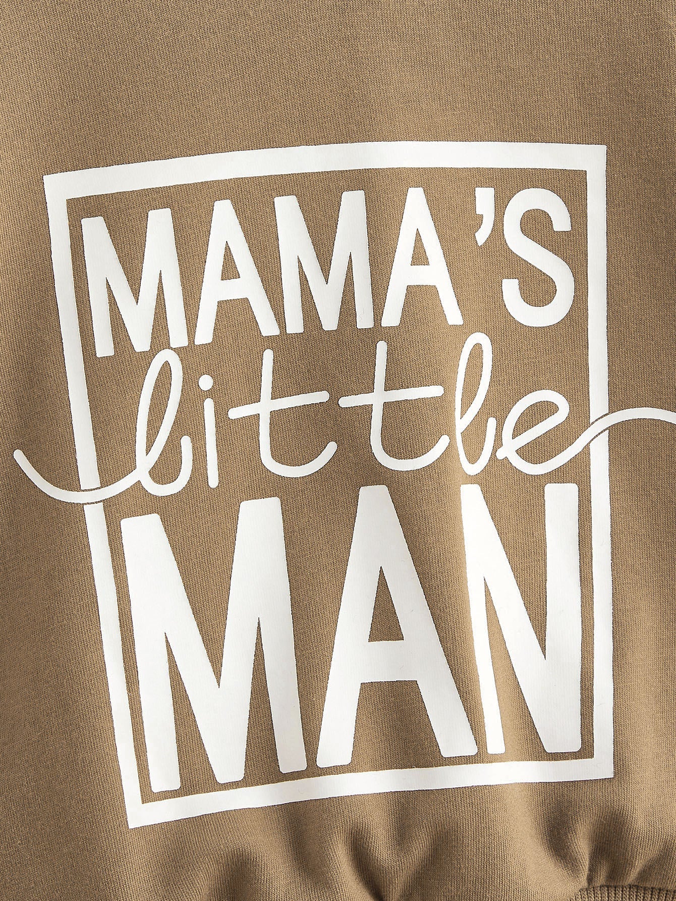 a man wearing a brown shirt that says mama's little man