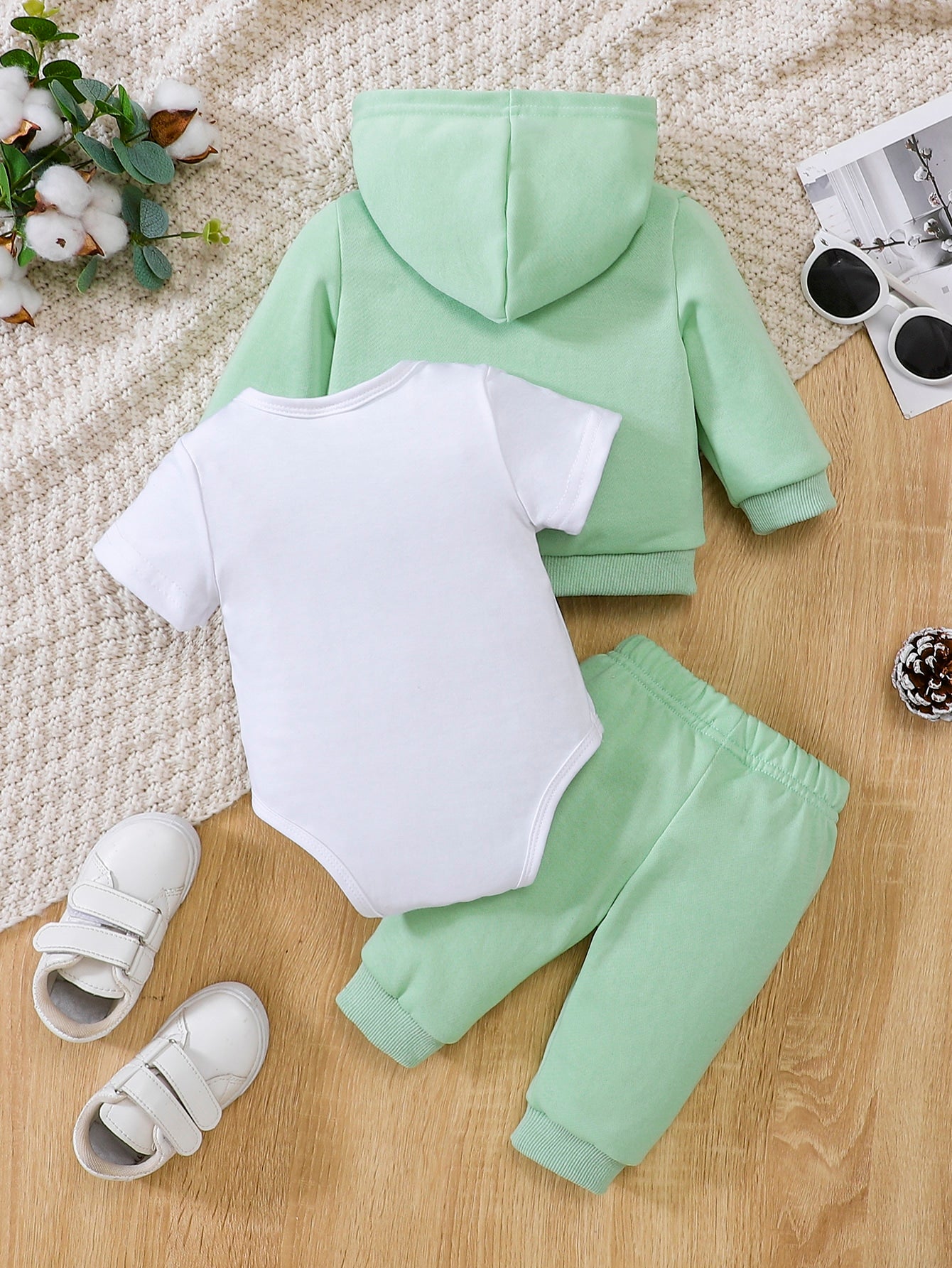 a baby boy's green and white outfit and shoes