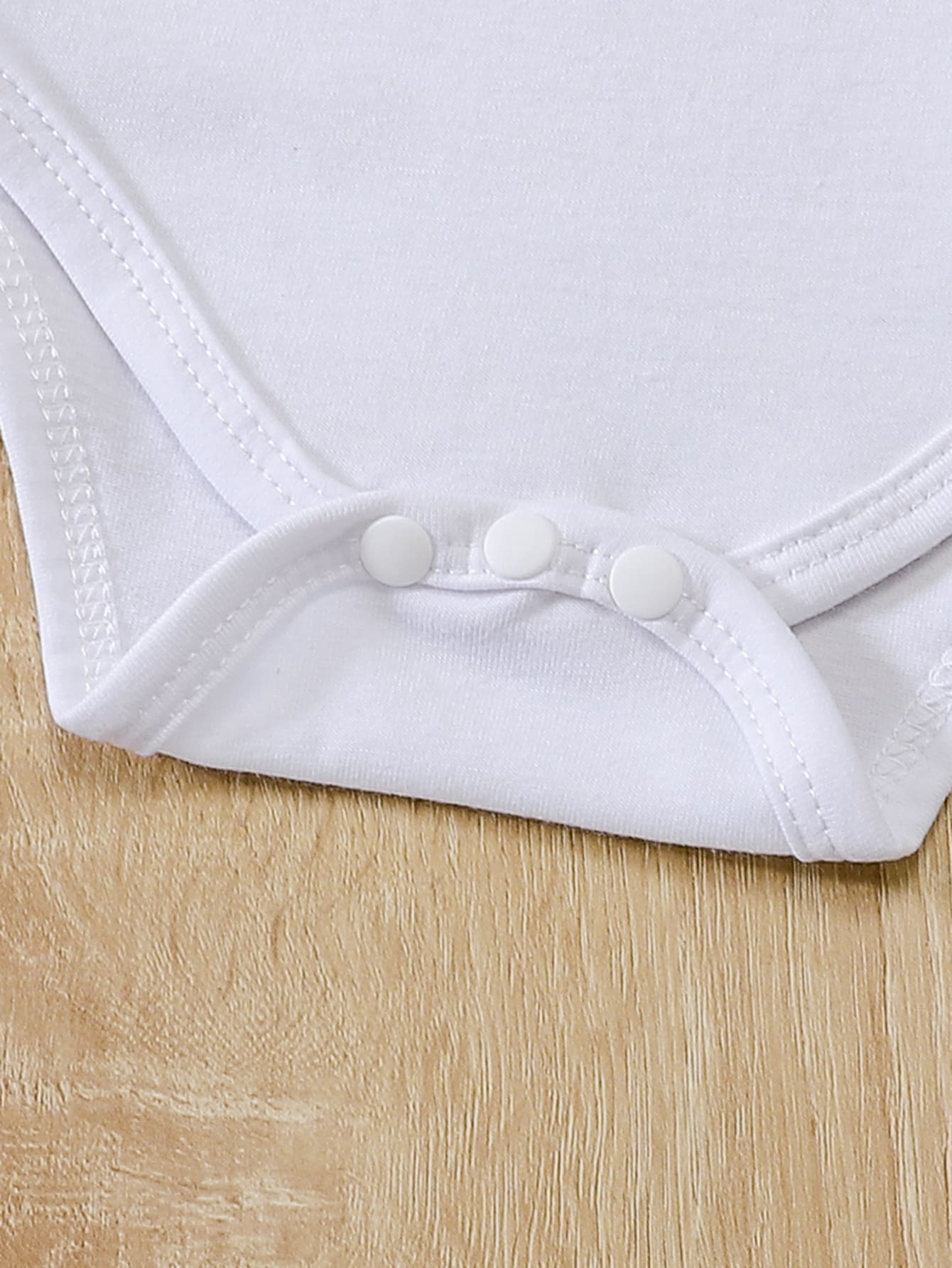 a close up of a white shirt on a wooden floor