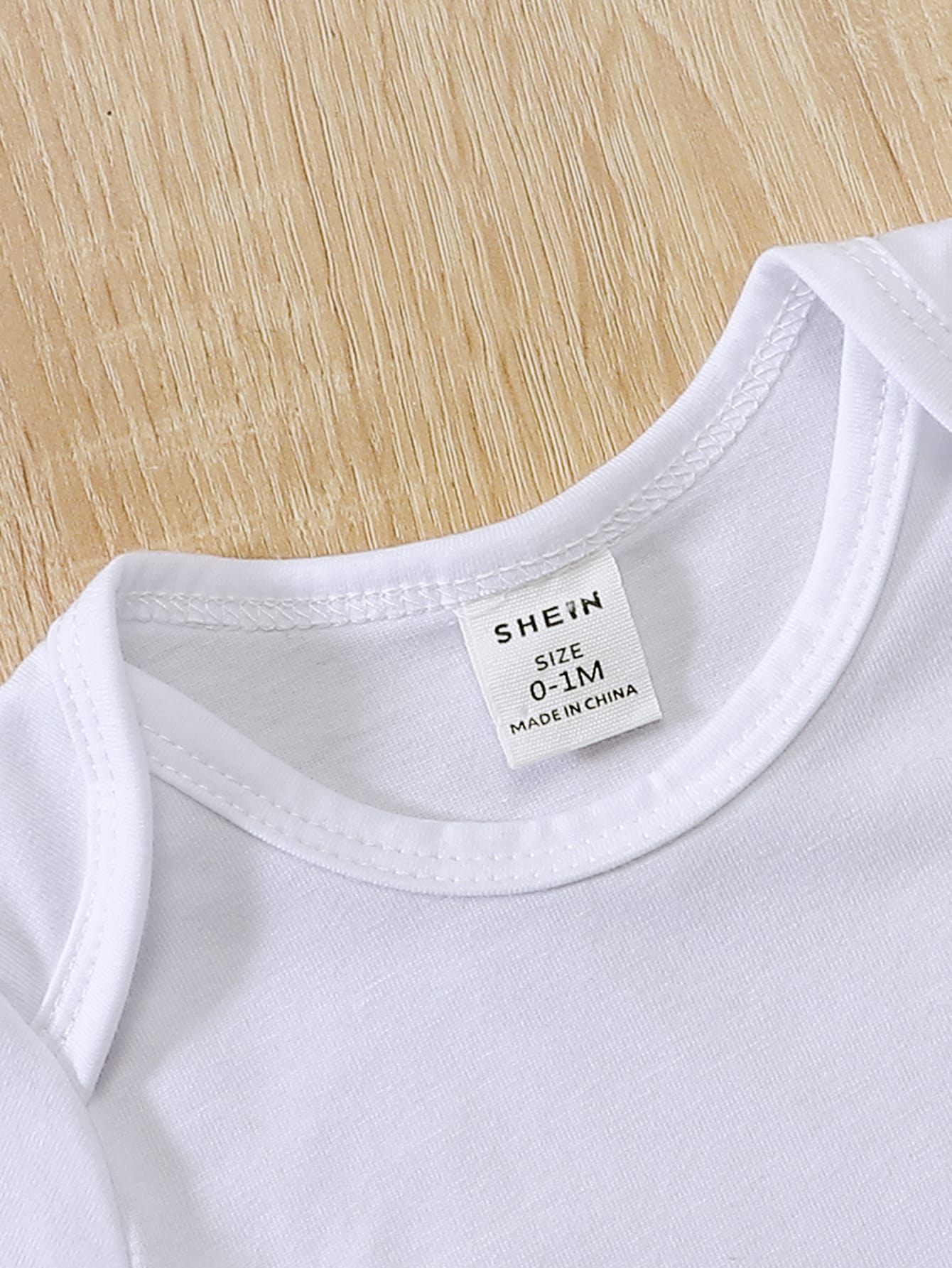 a white t - shirt with a tag on it