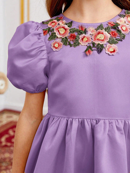 a little girl wearing a purple dress with flowers on it