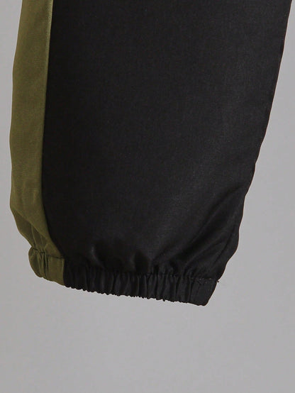 a pair of black and green pants hanging from a hook