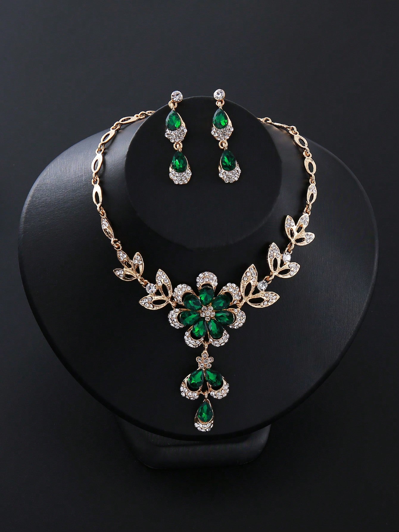 a necklace and earring set with green stones