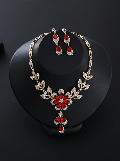 a necklace and earring set with red stones