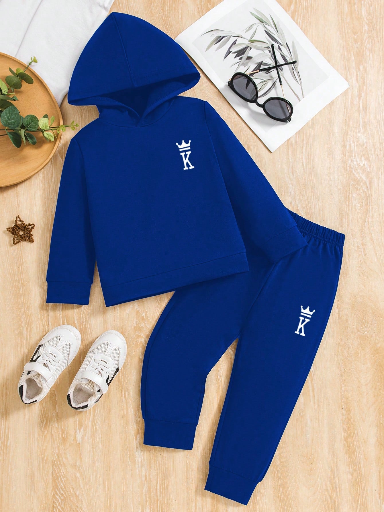 a blue hoodie and sweatpants with a pair of white shoes