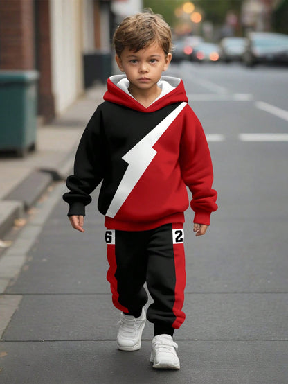 a young boy is walking down the street