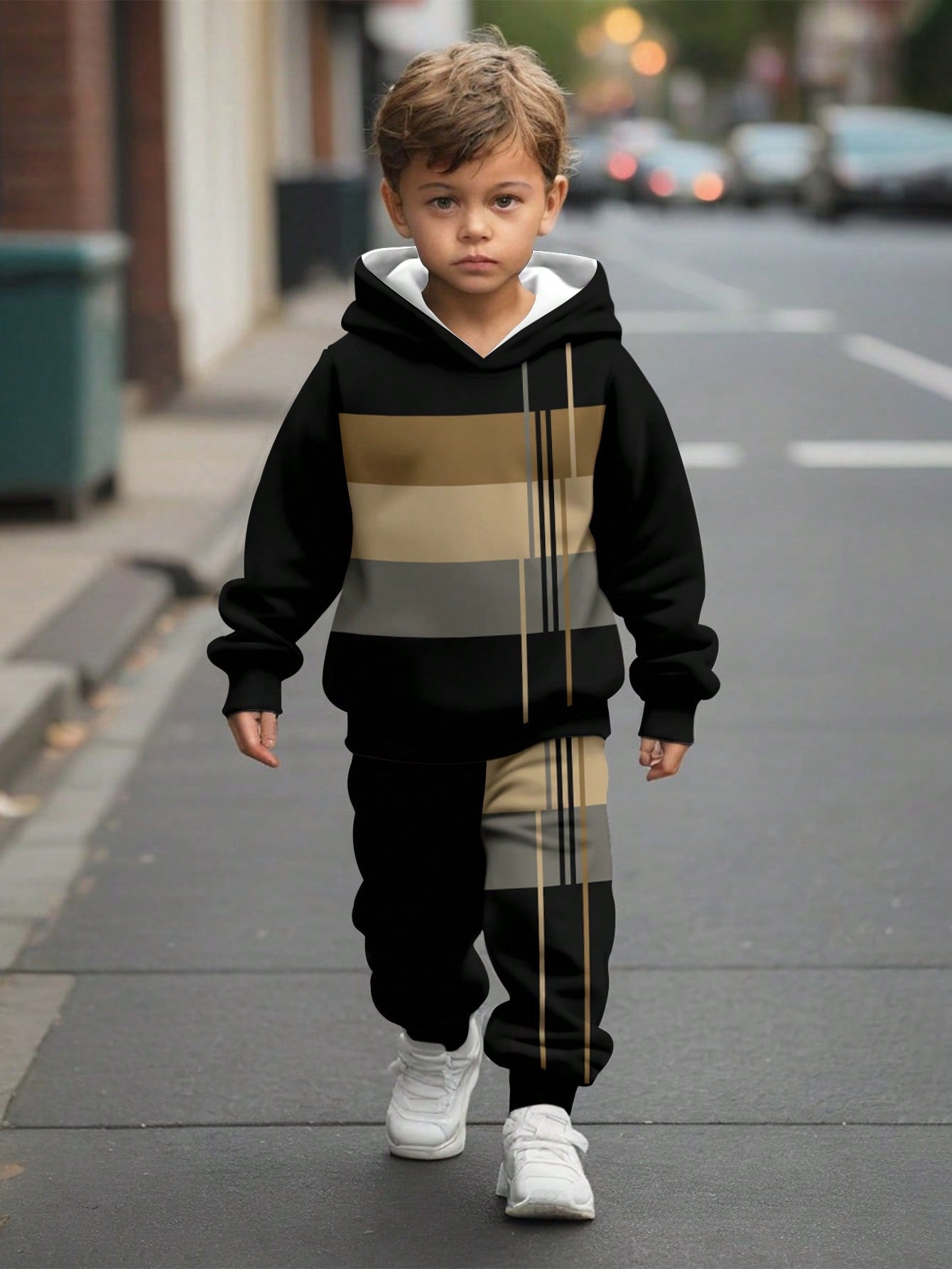 a young boy is walking down the street