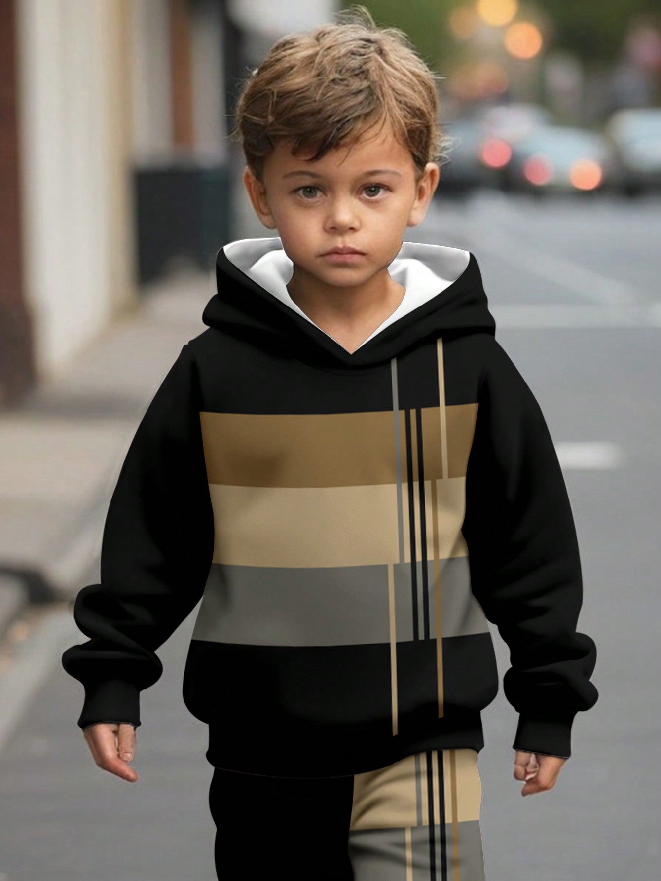 a young boy is walking down the street