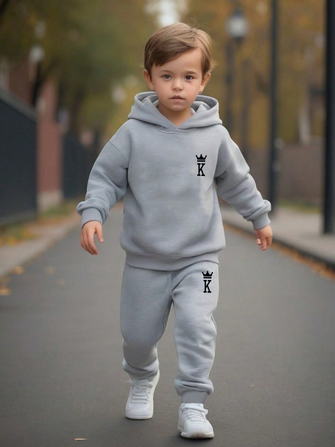 a young boy is walking down the street