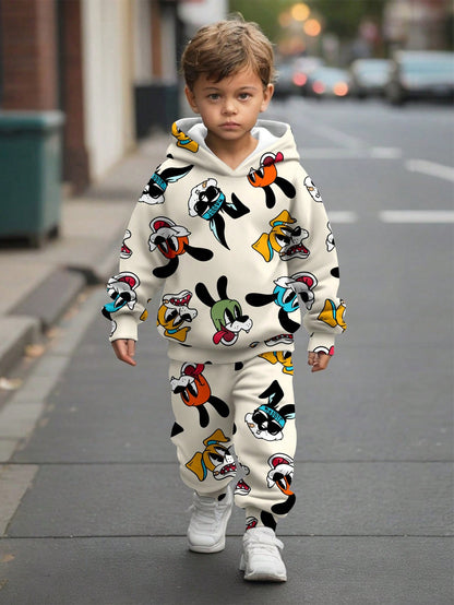 a little boy walking down the street in a mickey mouse outfit