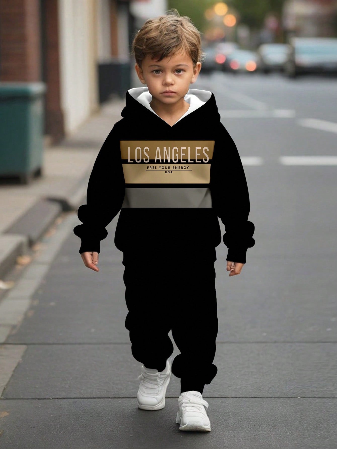 a young boy is walking down the street