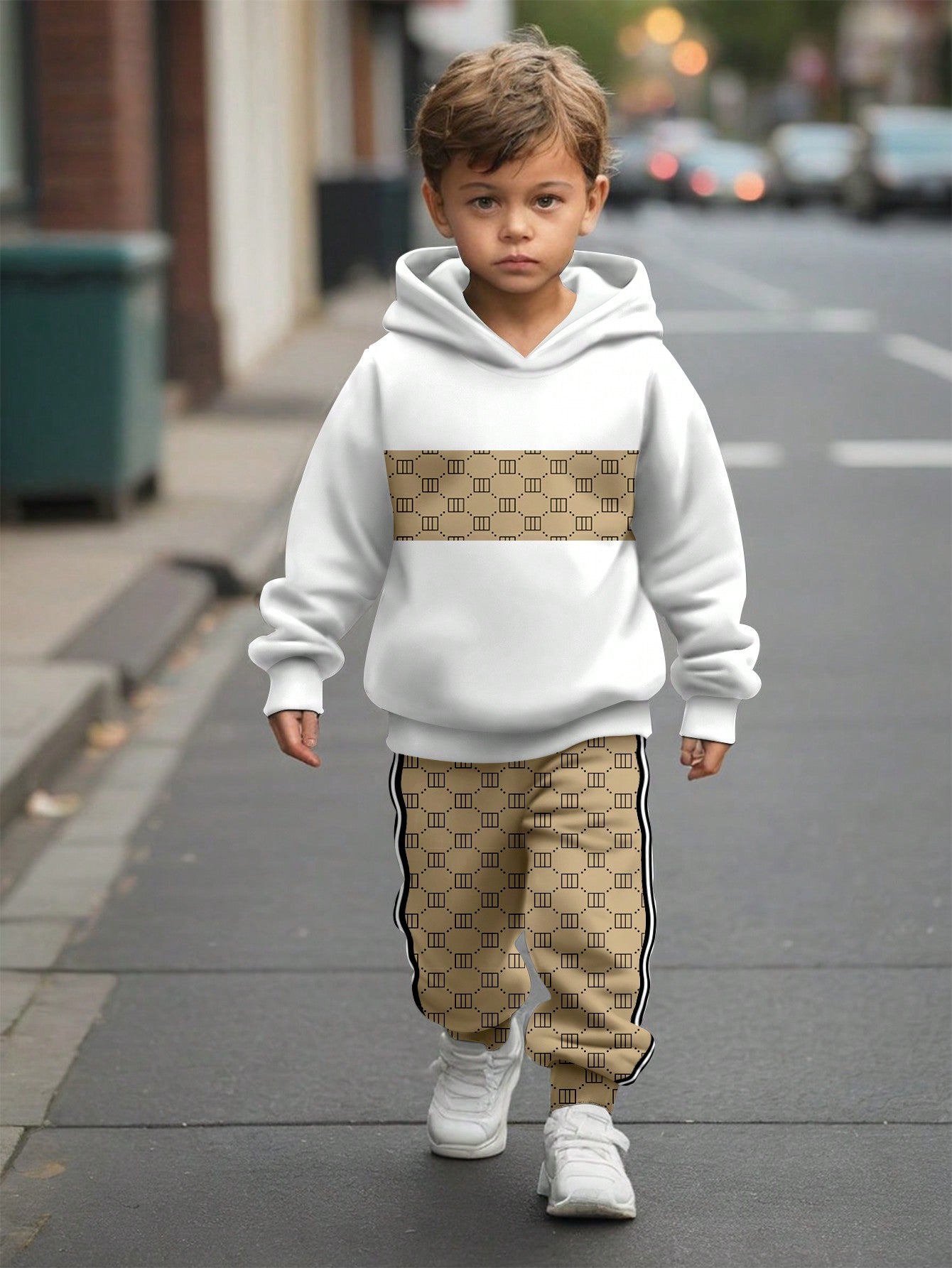 a young boy walking down a street wearing a white hoodie