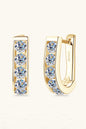 Elegant gold-tone earrings featuring sparkling moissanite stones set in a sleek, minimalist design.