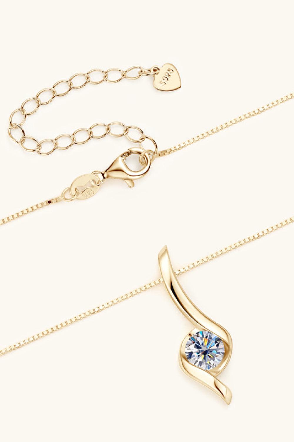 A gold chain necklace featuring a diamond-shaped pendant with a single sparkling gemstone accent. The necklace has a delicate, elegant design and appears to be made of 925 sterling silver with a gold finish, as indicated by the product details. The pendant is displayed against a plain, light background, highlighting its simple yet sophisticated style.